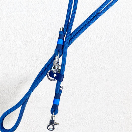 Close-up of the Sunny Sky Hands-Free Dog Lead, showing the nickel trigger clip, navy BioThane adjustable slider, nickel O-ring, and the detailed nano bindings on the Petrol Blue rope.