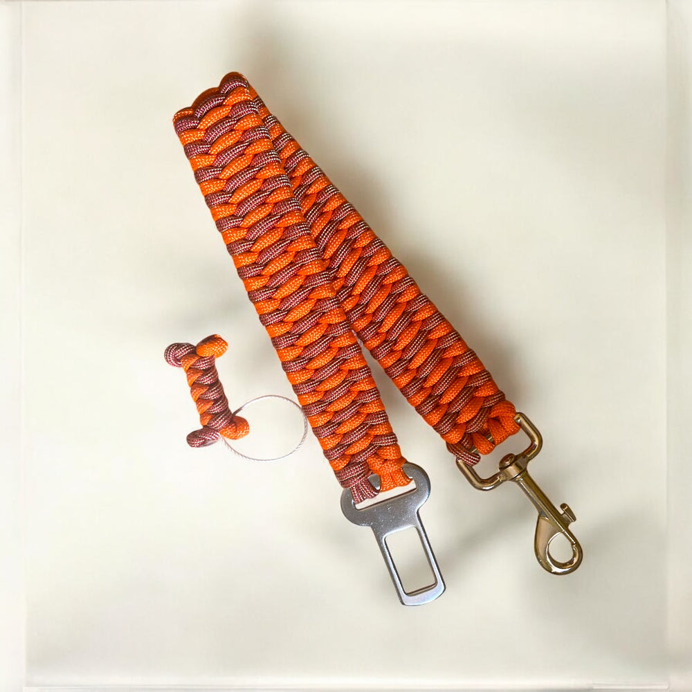Canine Seat Belt | Paracord Dog Seat Belt for Car Travel - Green Dog using Red and Gold paracord and burnt orange paracord with a matching bone tassel