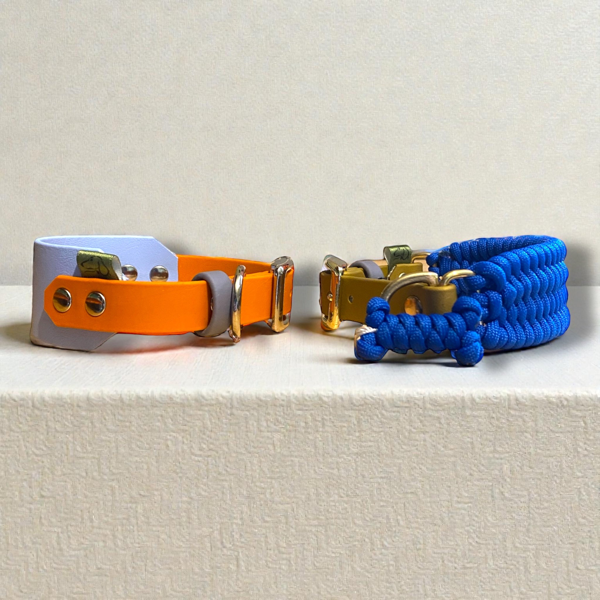 Two Monkey Blue variations from the Life Like Charlie collection in Monkey Blue. One pastel blue and burnt orange 38mm wide BioThane sighthound dog collar and one Royal blue & gold Biothane and 36mm paracord sighthound dog collar