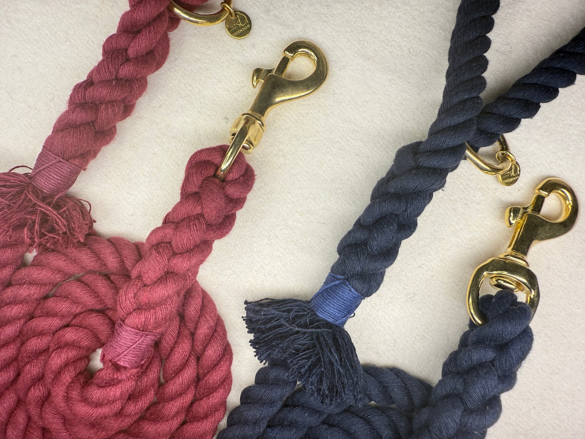 Close up of the Midnight blue and burgundy braided cotton rope dog leads with brass details