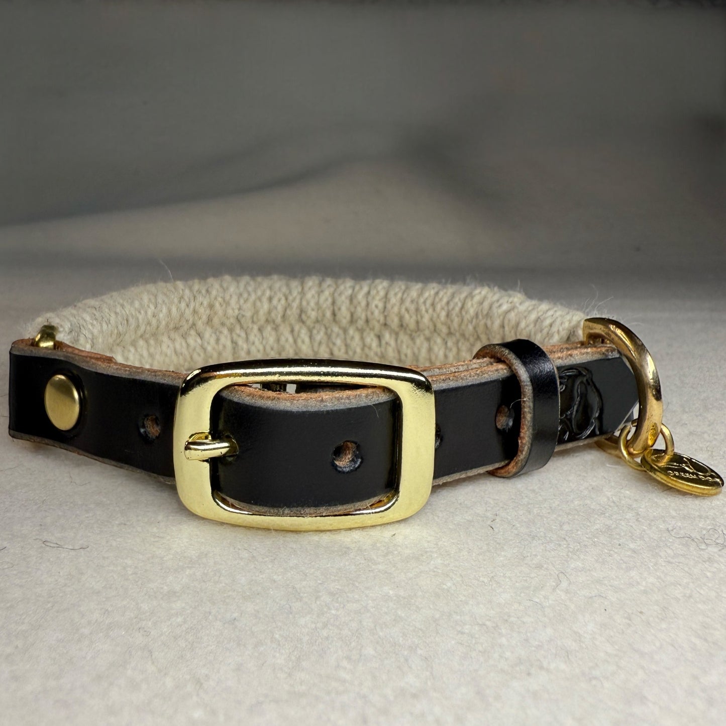 a small breed wool dog collar close up on a light woollen background