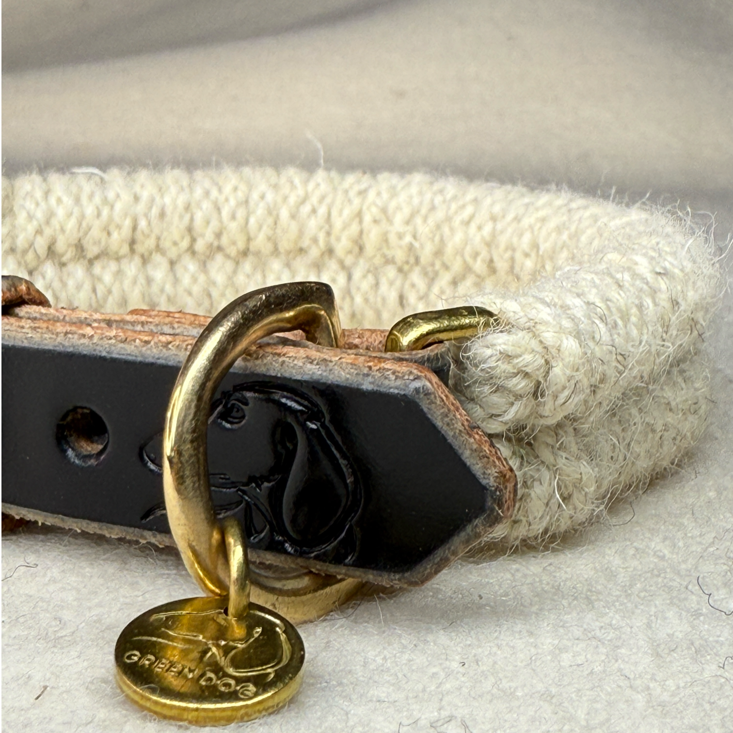 Close up of the Dingley wool rope dog collar on a light woollen background with brass details