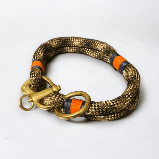 Side profile of the greenwich yarn dog collar chic camo edition in 10mm camouflage rope with navy blue and neon orange binding and brass hardware