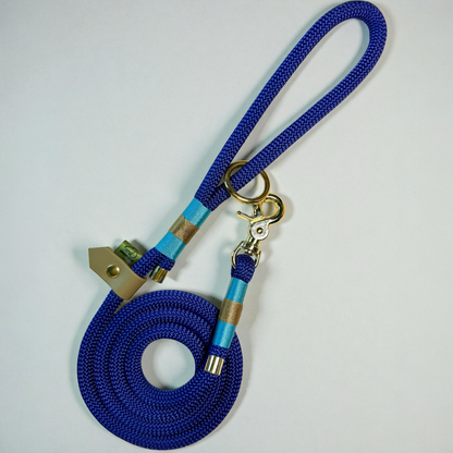 Luxury handmade rope dog lead in deep marina blue with light aqua and sand accent bindings, brass hardware, and comfortable loop handle. Sustainable, durable dog lead by Green Dog.