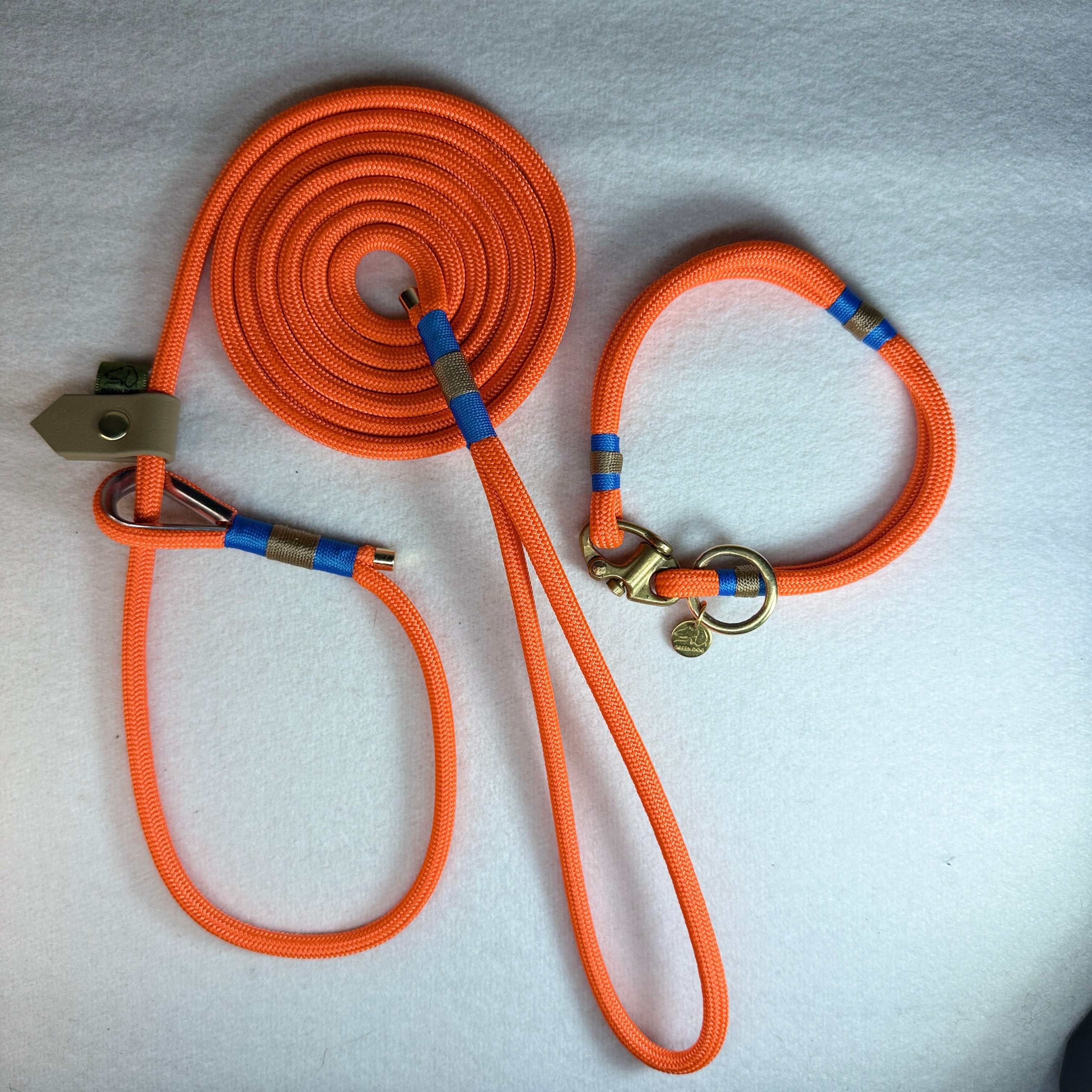 Matching Greenwich Yarn Mini set with a 6mm neon orange rope dog lead, classic blue and tan nano binding, beige BioThane slider, plus mini collar with a brass Swedish sailing shackle and small brass o-ring.