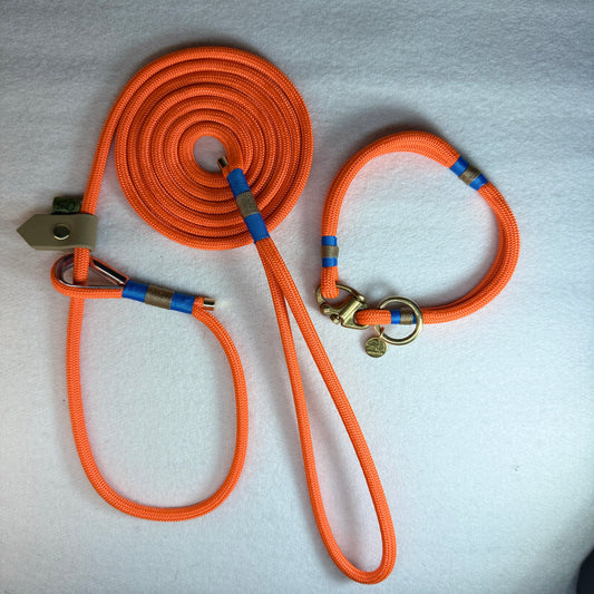 Matching Greenwich Yarn Mini set with a 6mm neon orange rope dog lead, classic blue and tan nano binding, beige BioThane slider, plus mini collar with a brass Swedish sailing shackle and small brass o-ring.