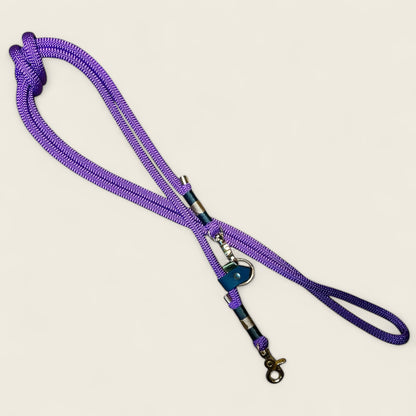 Centre Court 8ft hands-free rope dog lead in deep purple with Alpine Green and Tan nano binding, featuring gold hardware and adjustable sliding rings for cross-body or waist wear.