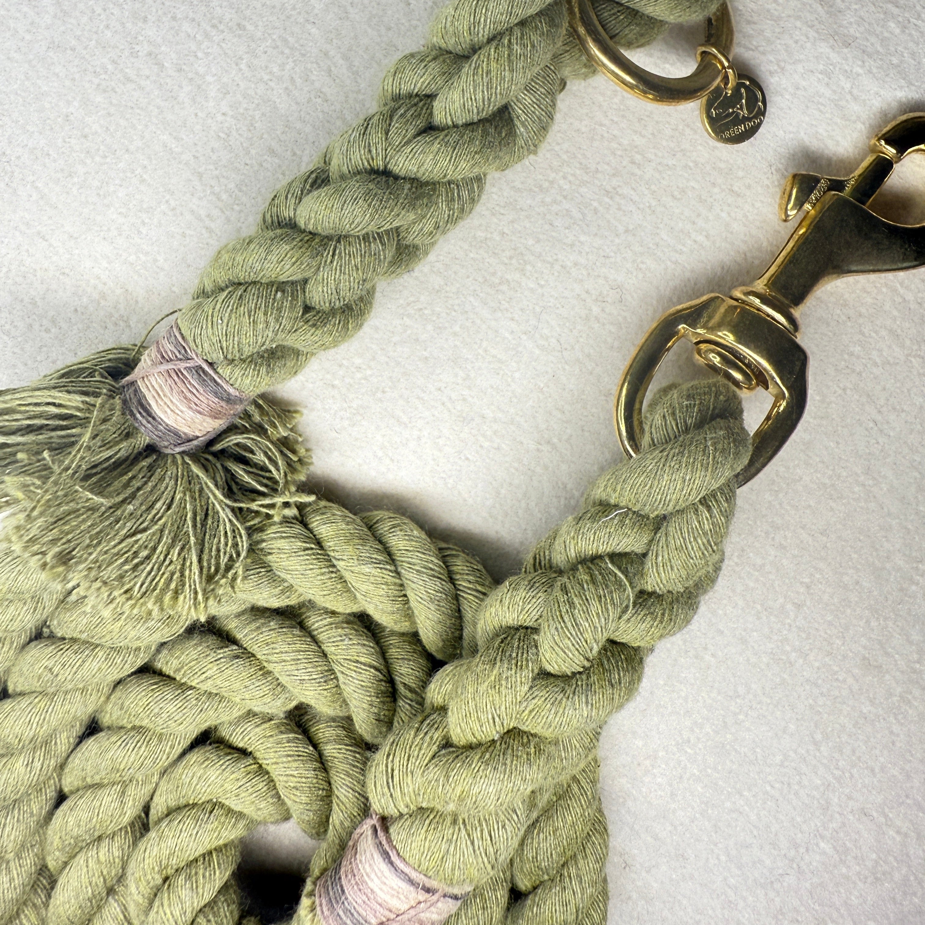 Olive Green Cotton braided rope dog lead with brass hardware on a light woollen background