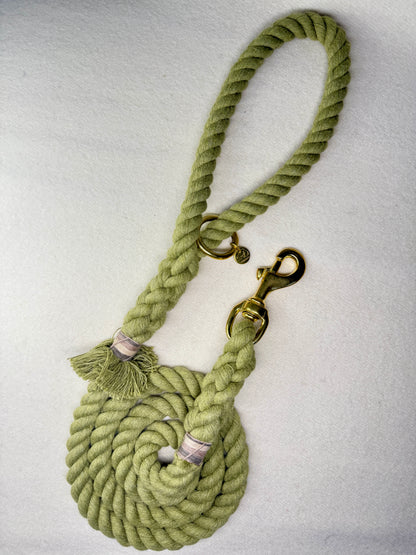 Olive Green Cotton braided rope dog lead with brass hardware on a light woollen background full view