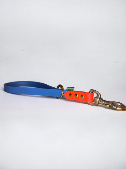 Custom BioThane short handle traffic lead in petrol blue and neon orange with nickel hardware, designed for close control during training.