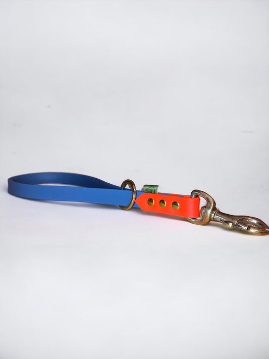 Custom BioThane short handle traffic lead in petrol blue and neon orange with nickel hardware, designed for close control during training.