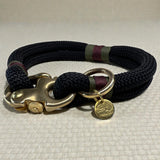 A close up side profile of the midnight edition greenwich yarn dog collar with olive drab, maroon bound detail and solid brass hardware
