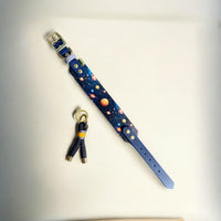 The Space Monkey Dog Collar next to the matching Greenwich Yarn keychain