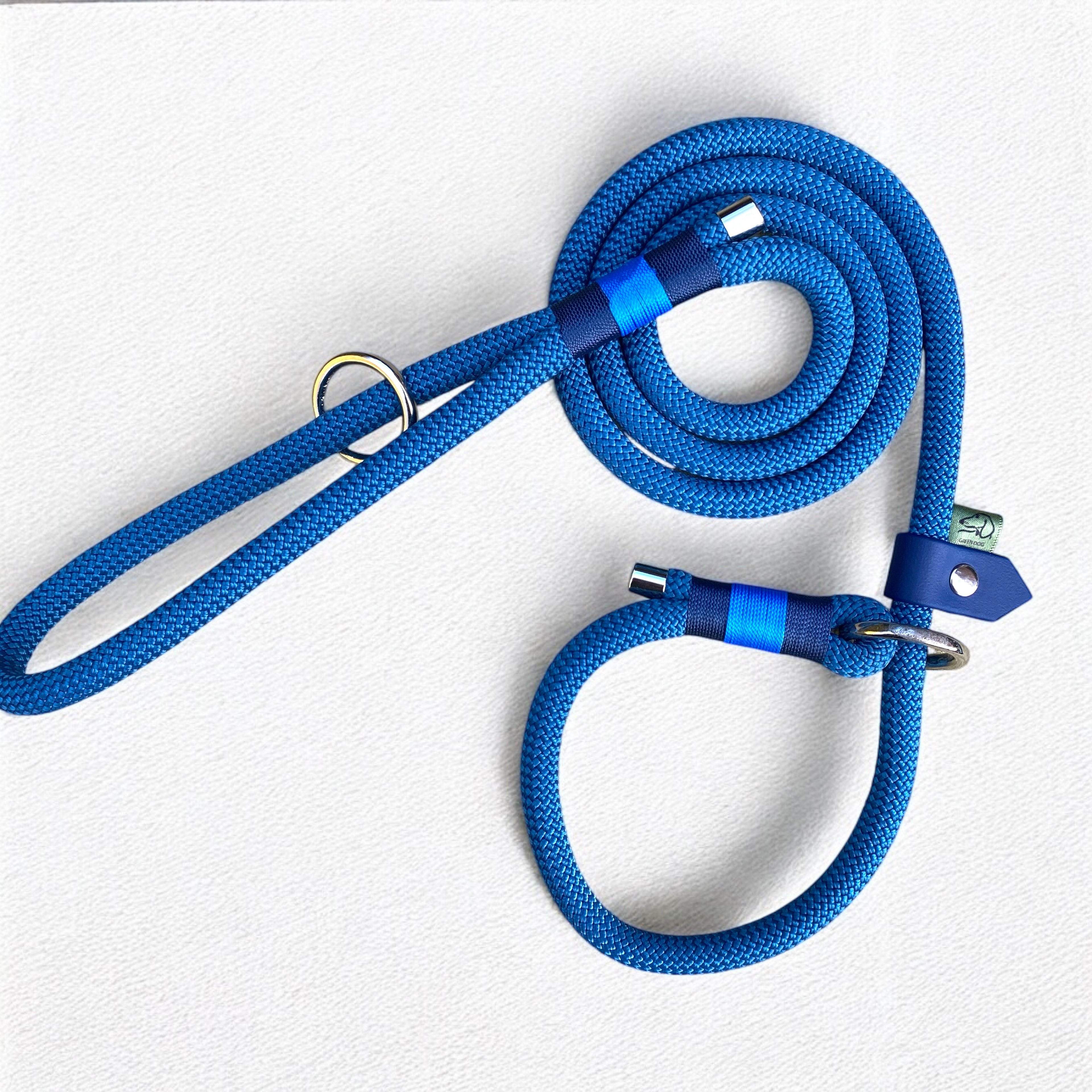 Close-up of the Sunny Sky Slip Lead for Dogs, highlighting the durable 10mm Petrol Blue rope, navy and blue nano bindings, nickel O-ring, and BioThane adjustable slider.