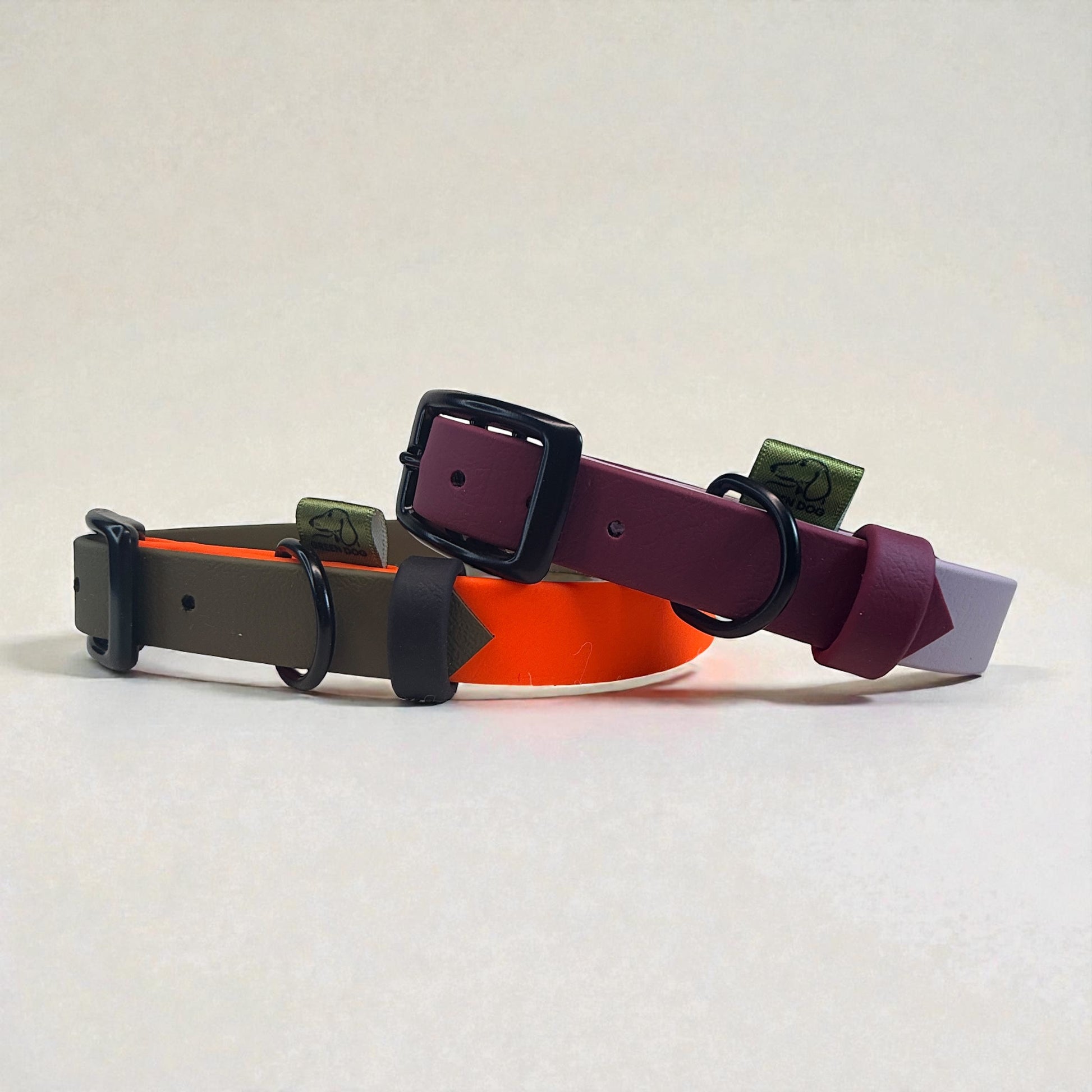Waterproof BioThane dog collars with black hardware, shown side-on: Pastel Purple and Maroon, Neon Orange and Military Green