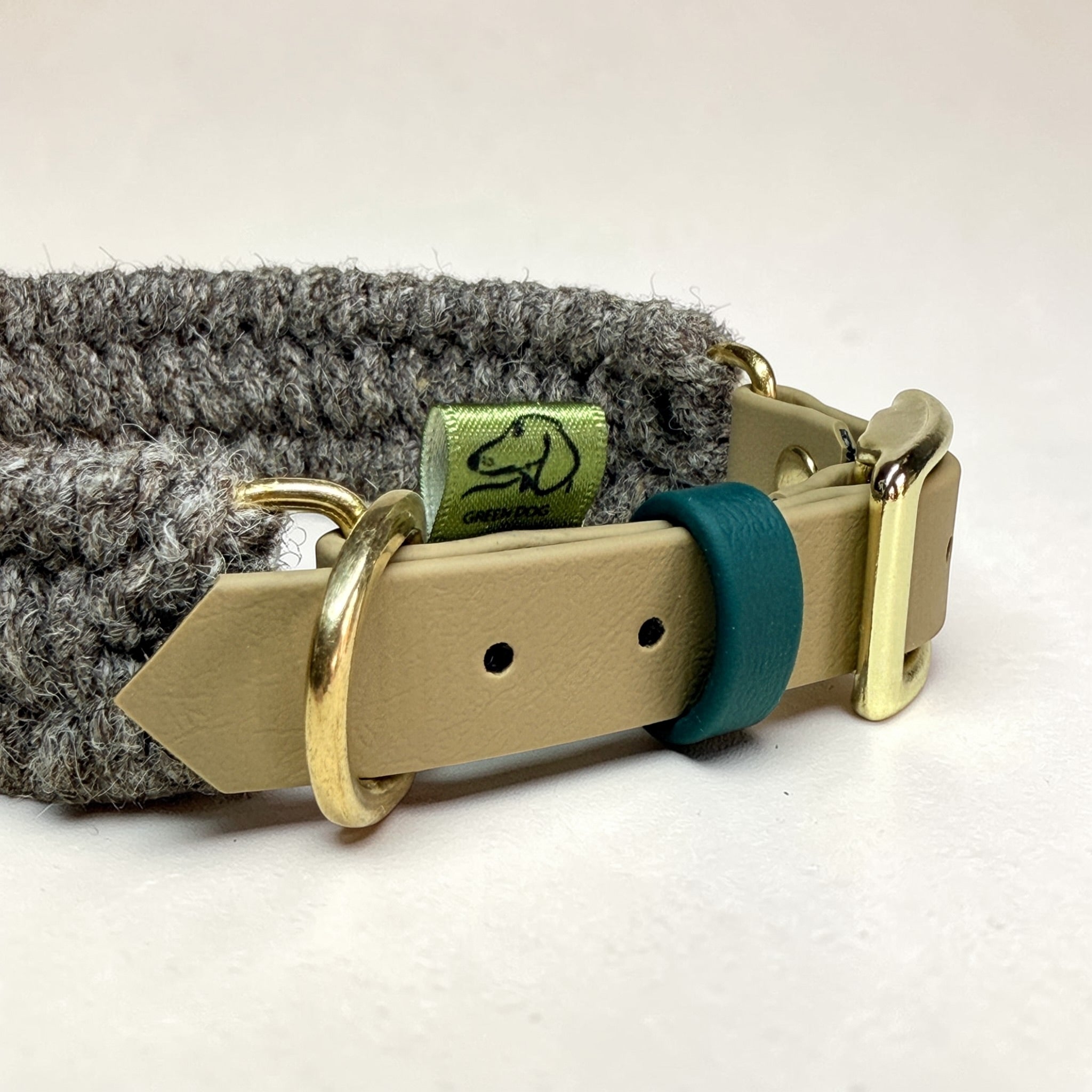 Detail of Brampton Hybrid collar hardware — beige BioThane strap, teal BioThane keeper, solid brass D-ring and Green Dog woven label, Sheep Shed Hybrid range handmade in Oxford