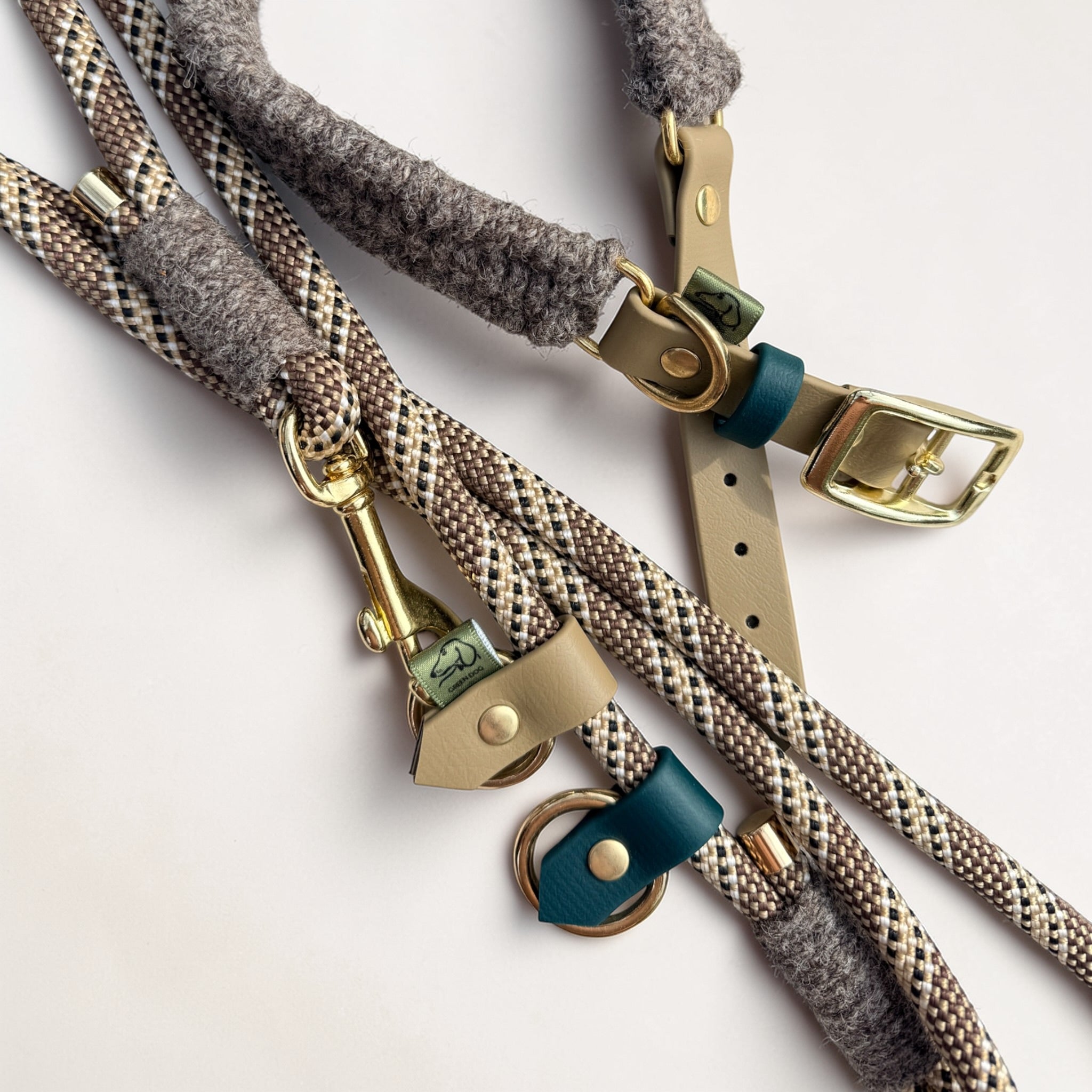 Close-up of Brampton Hybrid collar and lead together — beige BioThane strap with teal keeper and brass D-ring on collar, solid brass snap clip and beige BioThane stopper on chestnut rope lead, Sheep Shed Hybrid collection by Green Dog