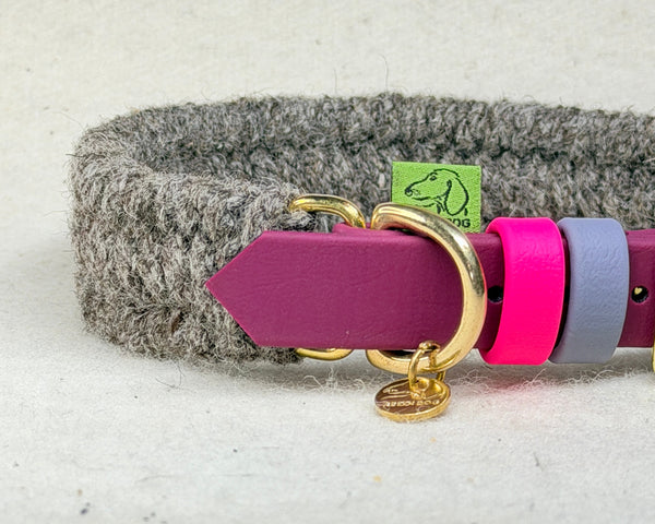 Close-up of the Brampton hybrid collar showing the charcoal wool weave, maroon BioThane strap, pink and grey 9mm keepers and the Green Dog woven label