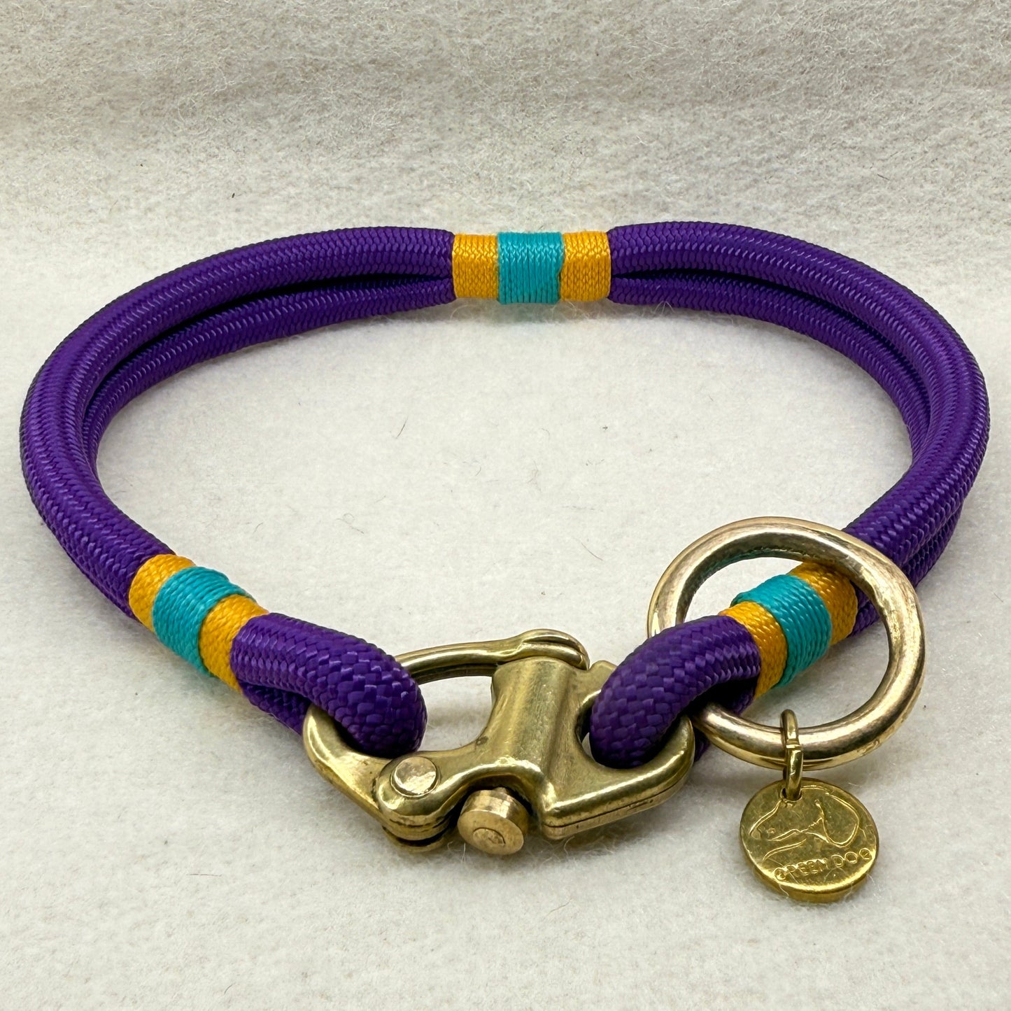 Side view of 6mm mini rope dog collar for small breeds in deep purple, finished with airforce gold and teal nano binding and brass hardware