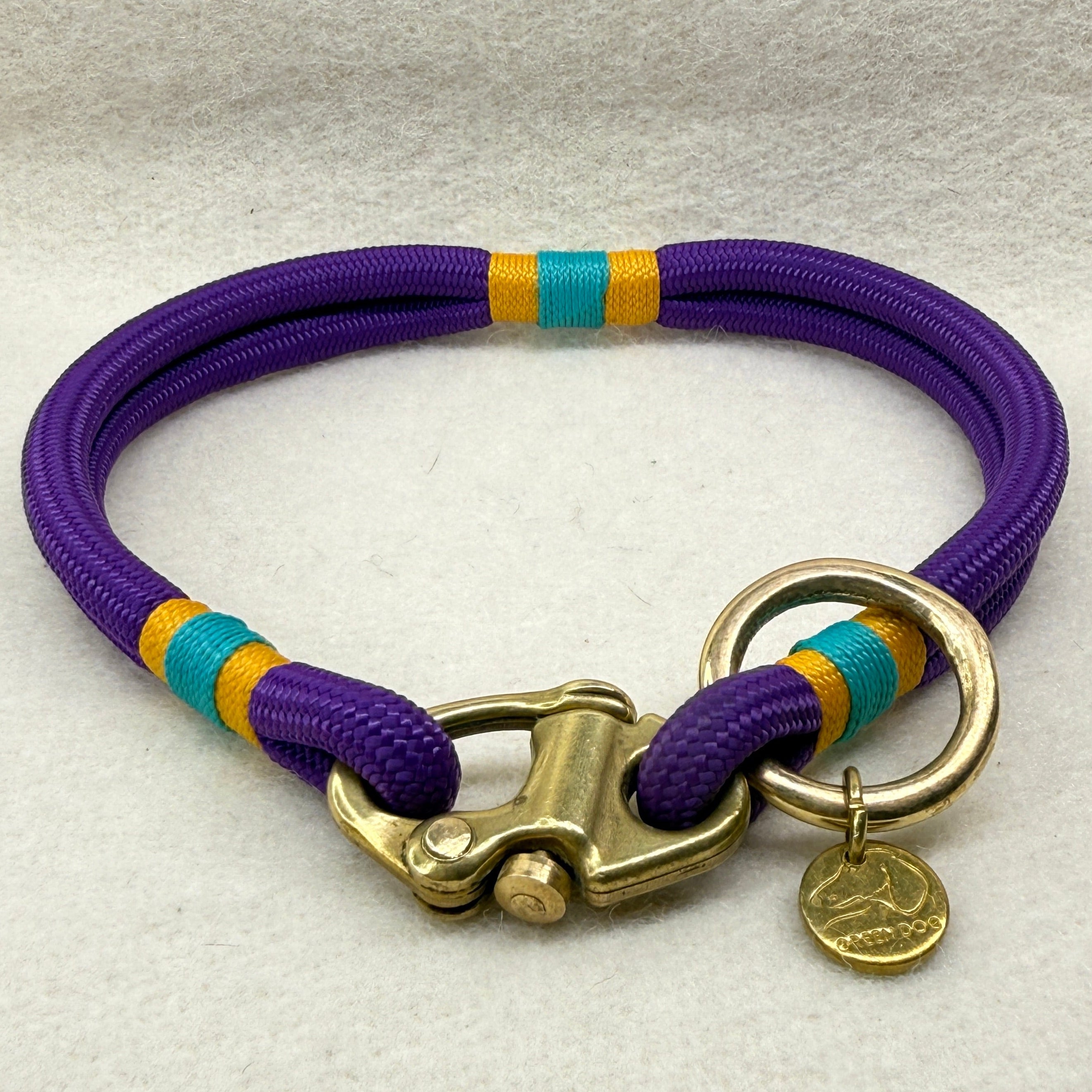 Side view of 6mm mini rope dog collar for small breeds in deep purple, finished with airforce gold and teal nano binding and brass hardware