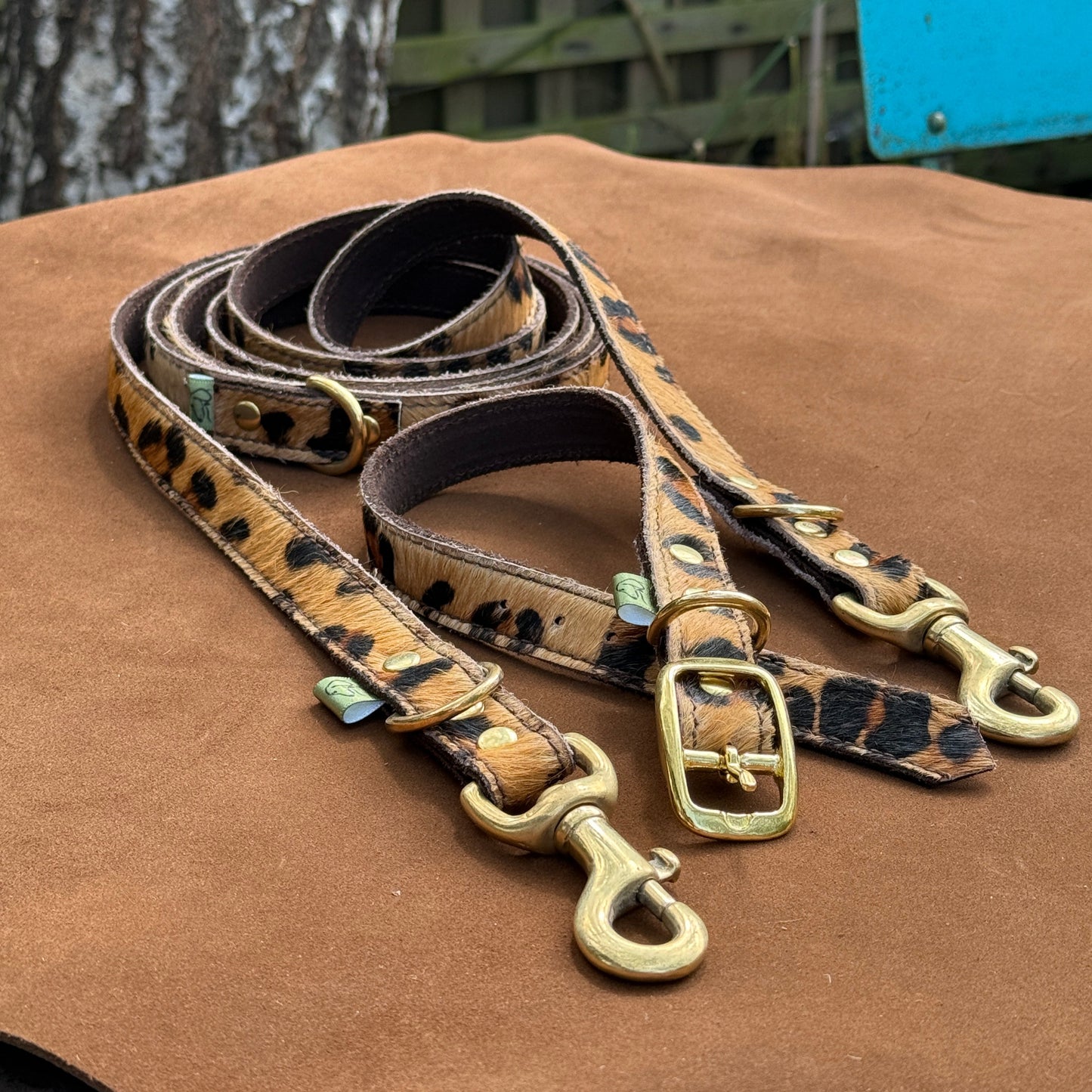 Handmade leather leopard print dog lead and matching leather collar with solid brass hardware, crafted in Oxfordshire.