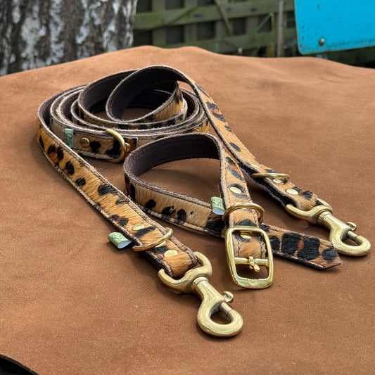 Handmade leather leopard print dog lead and matching leather collar with solid brass hardware, crafted in Oxfordshire.